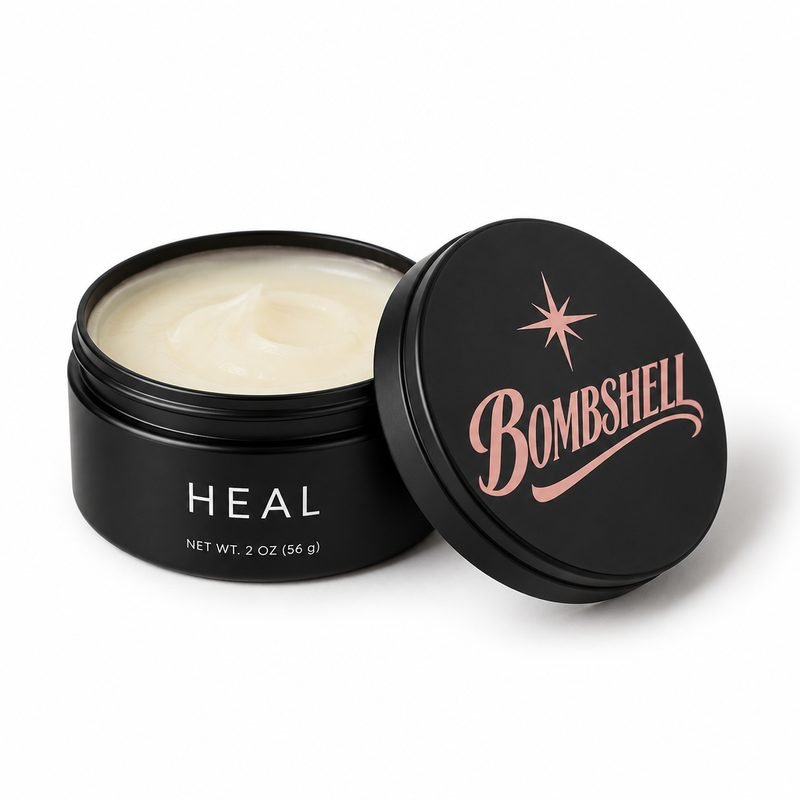 Concept render: an open black Bombshell tin of cream-colored balm, labeled HEAL (a working name).